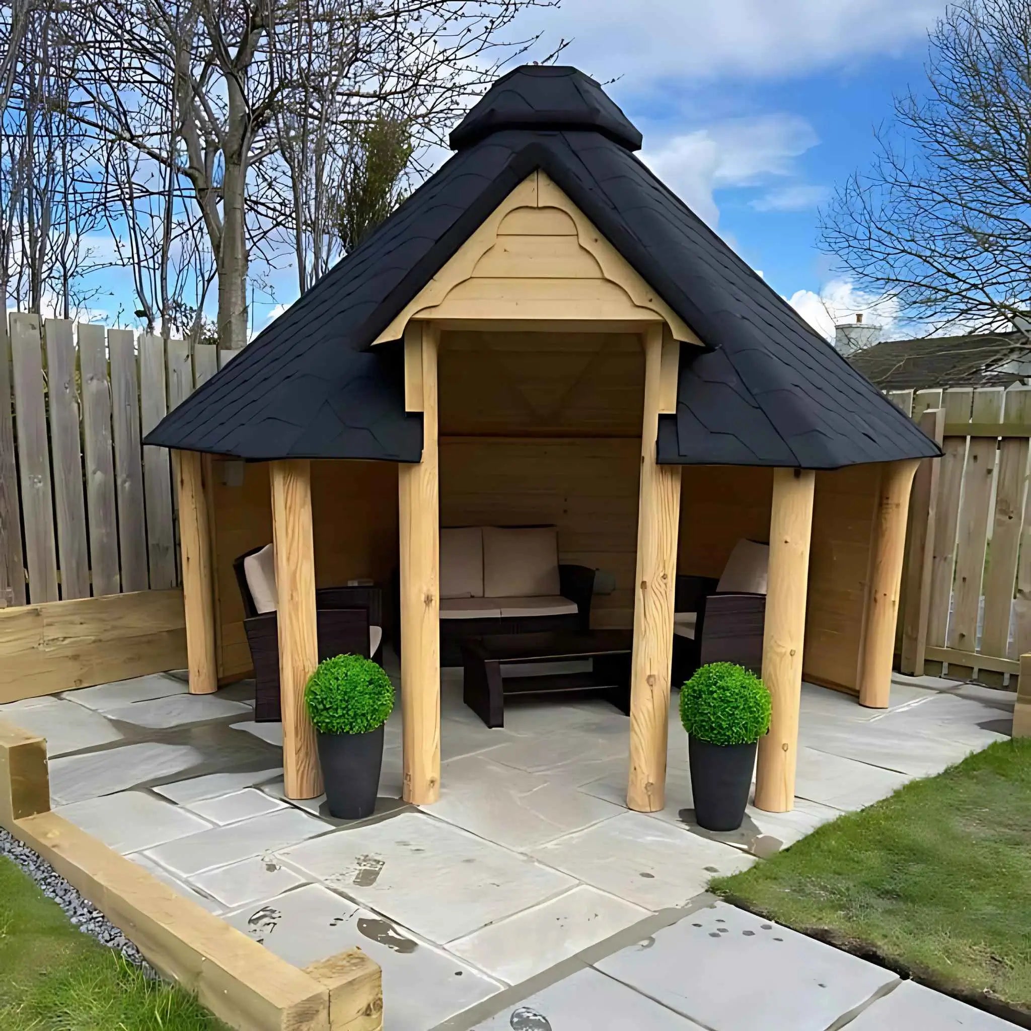 A full frontal view of The Valhalla Shelter, a handcrafted Viking-style gazebo with a spacious interior, elegant wooden pillars, and a weather-resistant roof for all-season outdoor enjoyment.